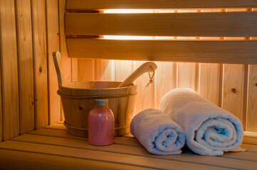 sauna interior with water bucket and towels