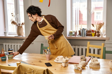 Creative moment in pottery studio with a stylish man engaged in ceramic art