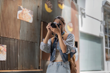 Passionate photographer capturing street art with camera