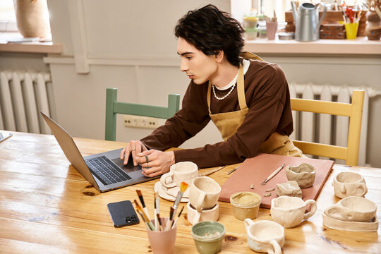 Handsome stylish man working on pottery projects in a creative ceramics studio - Powered by Adobe