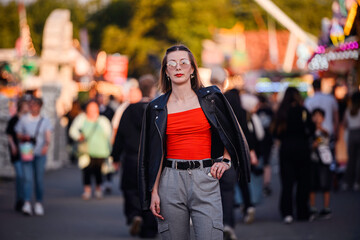 Confident Young Woman Walking Through Busy Outdoor Event