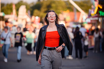 Confident Young Woman Walking Through Busy Outdoor Event