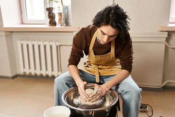 Handsome stylish man creating pottery in a creative studio filled with inspiration