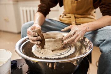 Handsome stylish man crafting pottery in a creative ceramics studio