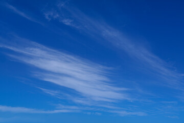 Blue summer sky with thin wispy clouds for use as a background texture