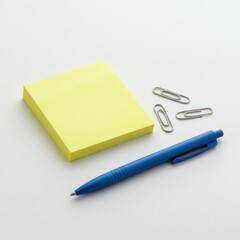 Yellow sticky notes, blue pen, and paper clips on white surface. Workplace    