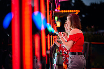 Excited Friends Competing at Carnival Light Game