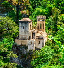 beautiful view of a nice old castle among rocks and green trees on background