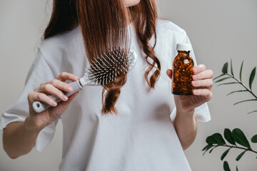 A woman holds omega-3 fish oil capsules. Healthy lifestyle, prevention and treatment of diseases. The woman takes and drinks dietary supplements and vitamins for skin, nails and hair. 