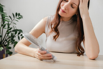 Health care, beauty treatment, hair loss problem. Shocked woman because at many hair lost in her hand and comb. Insufficient conditions in the body due to stress and depression