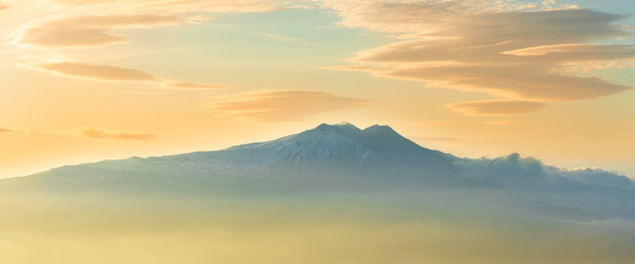 beautiful mountain sunset landcape with great magestic mountains and amazing slopes and canyons with evening clouds. Panorama of vulcano Etna in Sicily, Italy.
