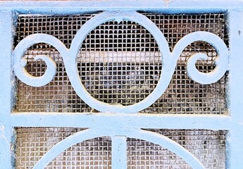 Door decorated with blacksmithing, rusty texture.