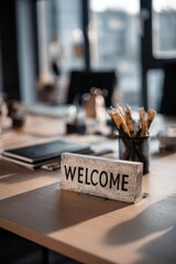 Naklejka premium Wooden welcome sign on a light brown table in a modern office space