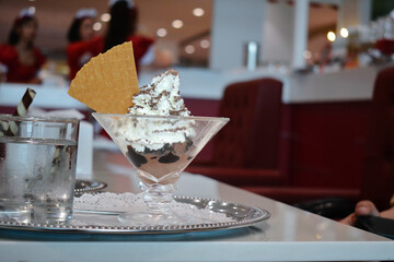 People are eating ice cream and snacks in a shop.