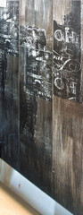 Distressed wood tile pattern with vintage graphics resembling old documents, currency, and stamps....