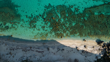 Turquoise Waters, Rocky Shoreline, and Beach Shadows – Aerial View of Mediterranean Coast in Calabria, Italy
