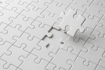 Empty Puzzle Pieces with One Missing Piece on Plain White Surface Ideal for Concept of Completeness, Problem Solving, or Missing Element in Visual Presentation