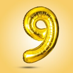 A shiny, golden number nine balloon on a bright yellow background. Ideal for birthday parties and...