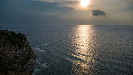 Fototapeta premium Sunset Over Cliff and Sea – Aerial View of Mediterranean Coast in Calabria, Italy