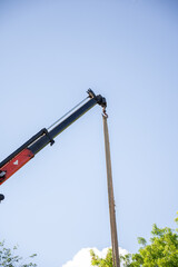 Obraz premium Crane on a truck for unloading wooden boards