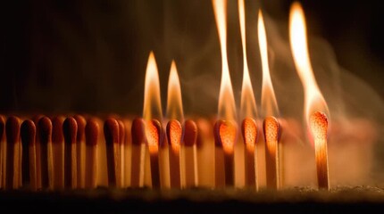 Close-up of matches igniting in sequence