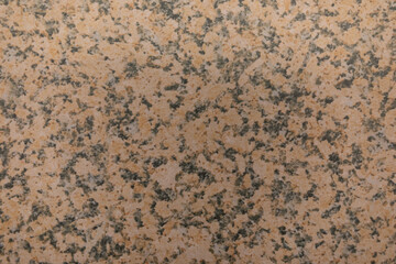 Textured granite surface with earthy tones and subtle patterns displayed in close-up view