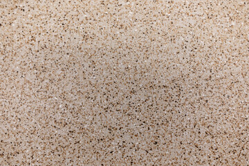Granite countertop surface showcasing a light beige pattern with specks in a residential kitchen setting