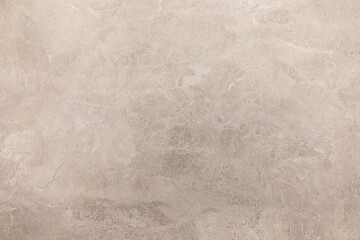 Natural beige stone surface with subtle textures and patterns suitable for various design applications