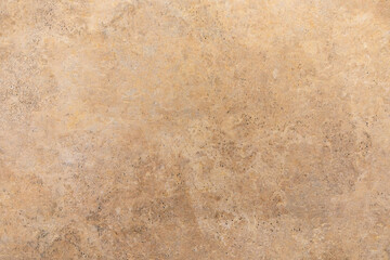 Background of textured brown surface showing natural patterns and light variations in a warm setting