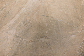 Natural stone surface with intricate patterns and textures in a neutral color palette for interior design applications