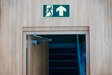 Emergency exit sign on the door of a hotel, emergency exit.
