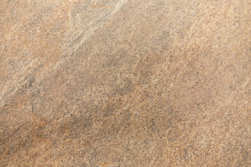 Natural stone surface with a textured pattern showcasing earthy tones and variations perfect for home design projects