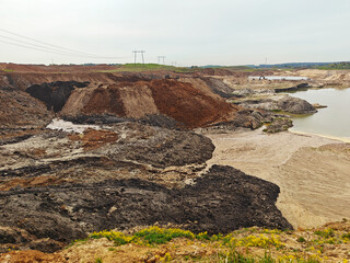 Yellow-orange toxic waste in water in sandpit