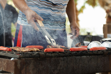 Cook grilling roast beef and hot dogs in northern mexico