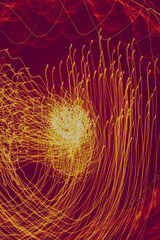 Intricate patterns of light dance in vibrant red hues at dusk