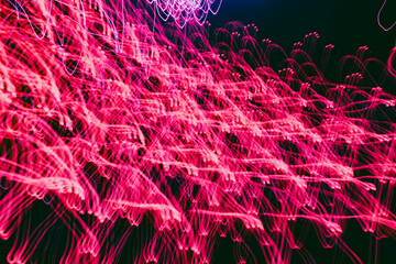 Vibrant light trails dance in a night sky full of energy and movement