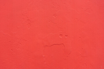 Vibrant red wall texture showcasing artistic craftsmanship and urban charm