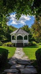 Serene white gazebo nestled within lush greenery viewed through a leafframed perspective