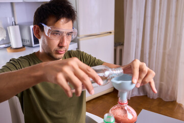 A Young Scientist Conducting a Home Experiment with Proper Safety Gear for Protection