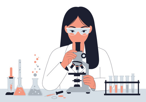 A scientist with goggles looks through a microscope surrounded by lab equipment on a white surface