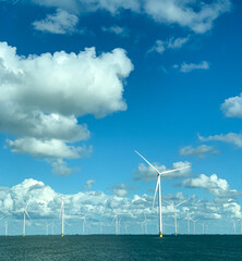 Offshore wind turbines in the sea, showing clean energy infrastructure, sustainability, and green...