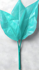 Teal leaf arrangement on light gray surface
