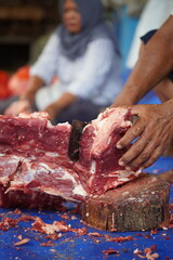 workers process goat meat for eid al-adha