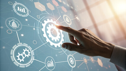 A hand interacting with a digital interface showing gears and chart icons on a screen display panel