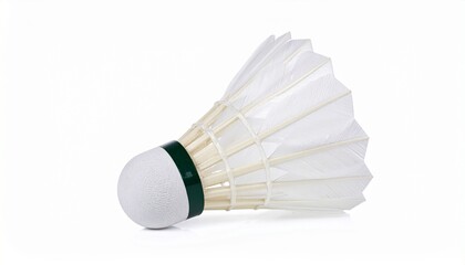 A white shuttlecock with a green band and delicately arranged feathers rests against a soft surface—evoking motion, sport elegance, and the graceful dynamics of badminton.