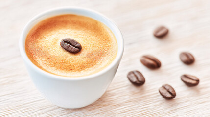 Obraz premium Artisan Latte Coffee in White Cup, Cozy Cafe Ambience, Food Photography, Warm Vibes