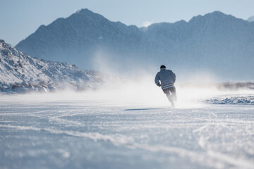 passionate hockey player wearing traditional felt boots skates joyfully across pristine winter landscape