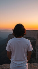 Fototapeta premium Person gazing at sunset over mountains