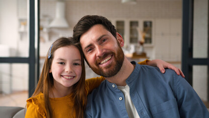 Happy carefree family portrait Caucasian child little girl kid daughter hugging cuddle touch dad...