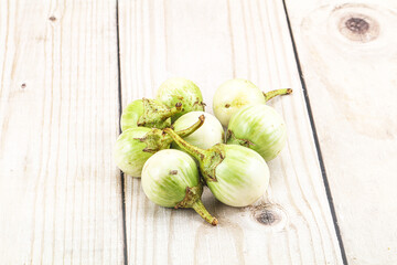 Small organic young green round eggplant